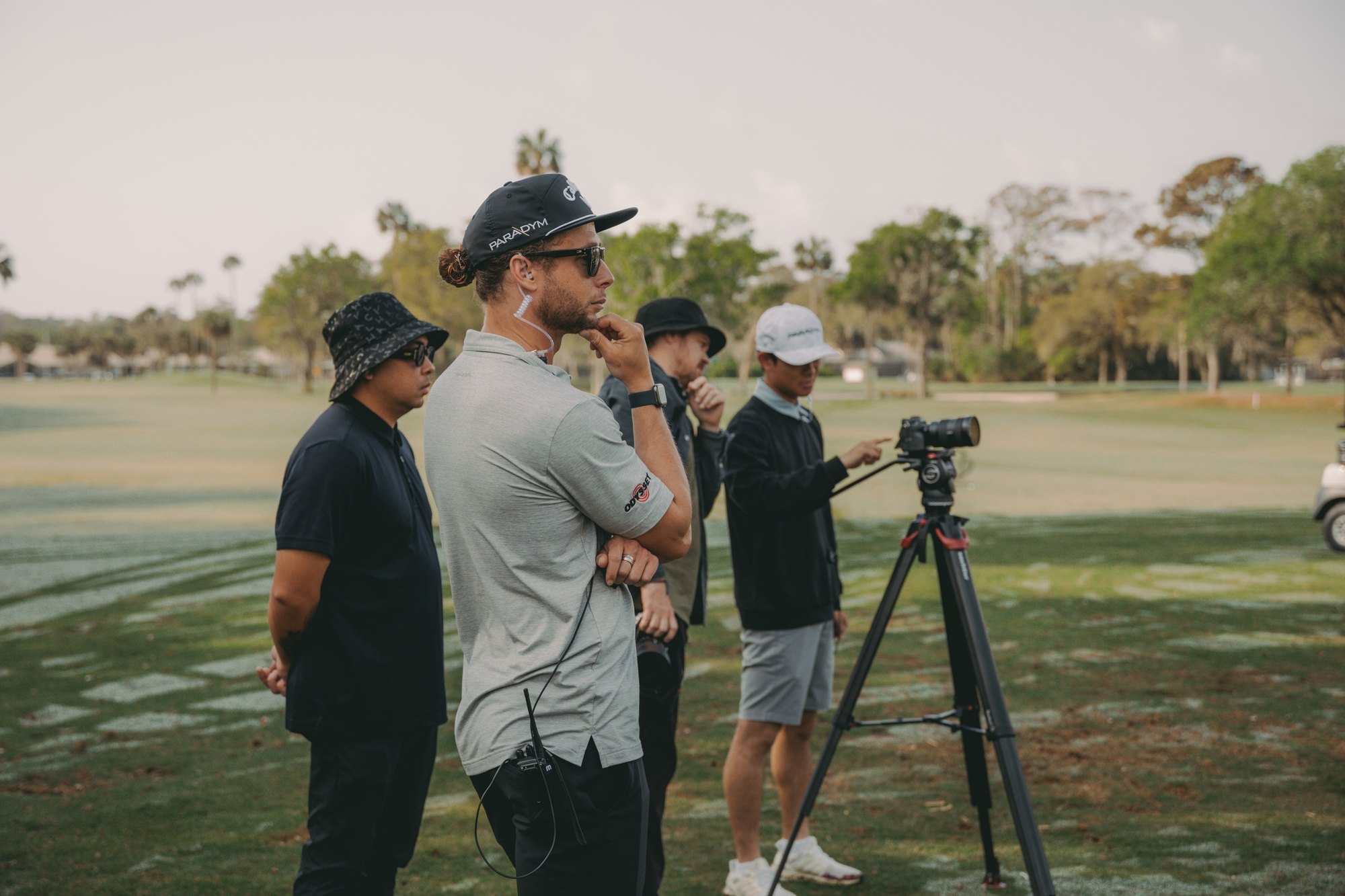 Cliff directing on set with crew and a camera on a golf course
