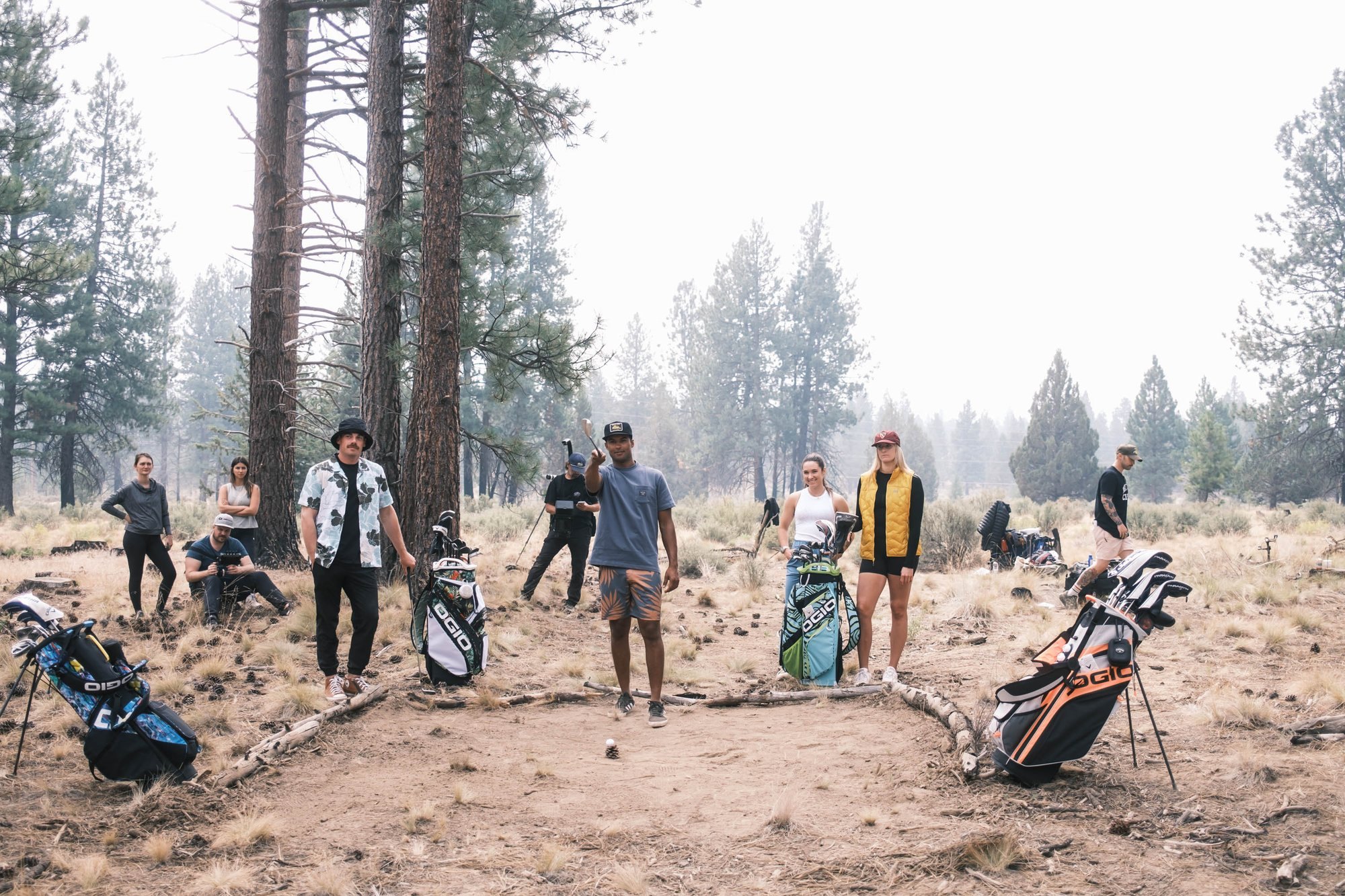 Behind the scenes: cast and OGIO golf bags in the forest