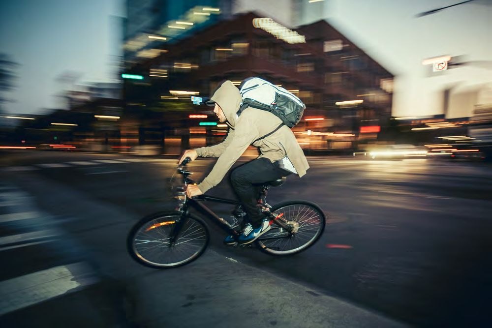 Cyclist with OGIO backpack in motion blur