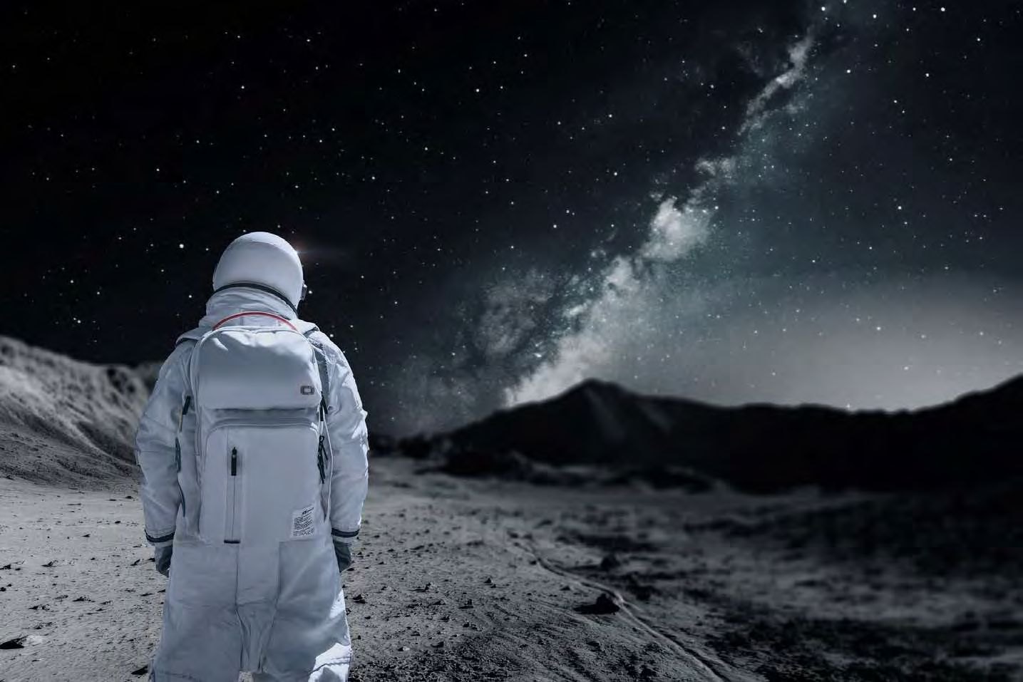 Astronaut wearing OGIO backpack under the Milky Way