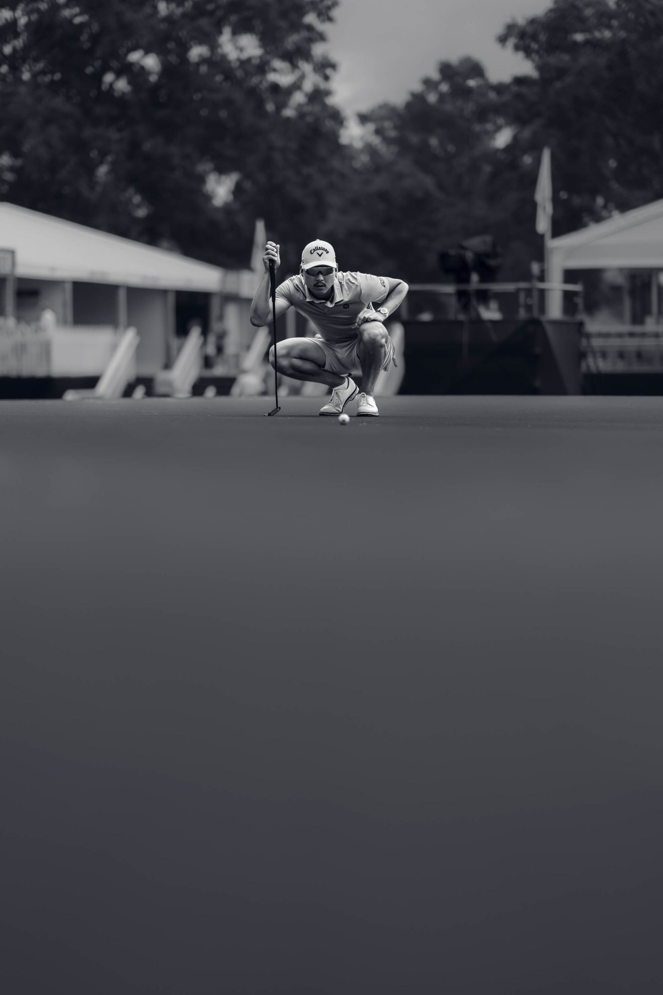 Tour player lining up a putt